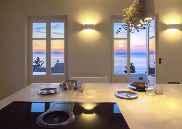 villa-da-lula-agios-nikitas-greece-indoor-dining-with-sunset