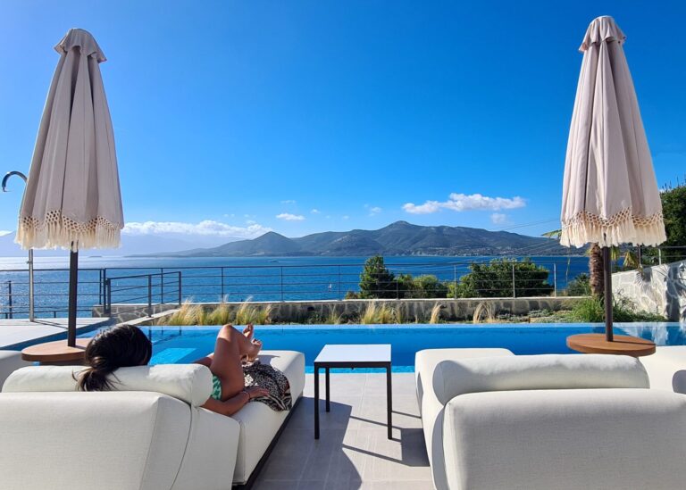 villa-empeiria-paleros-greece-umbrella-sky-girl-sitting-swimming-pool-scaled